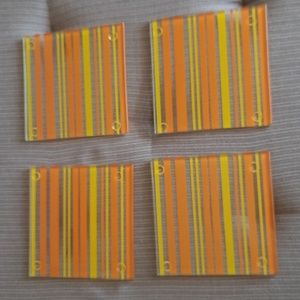 A set of 4 Yellow/orange/clear Striped glass coasters